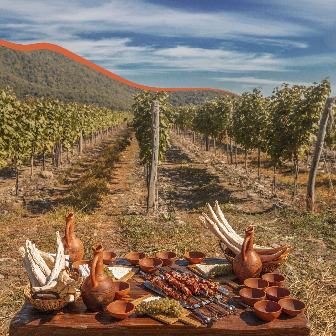 Food-table-in-Vineyard-with-mountains-background Food Table In Vineyard With Mountains Background